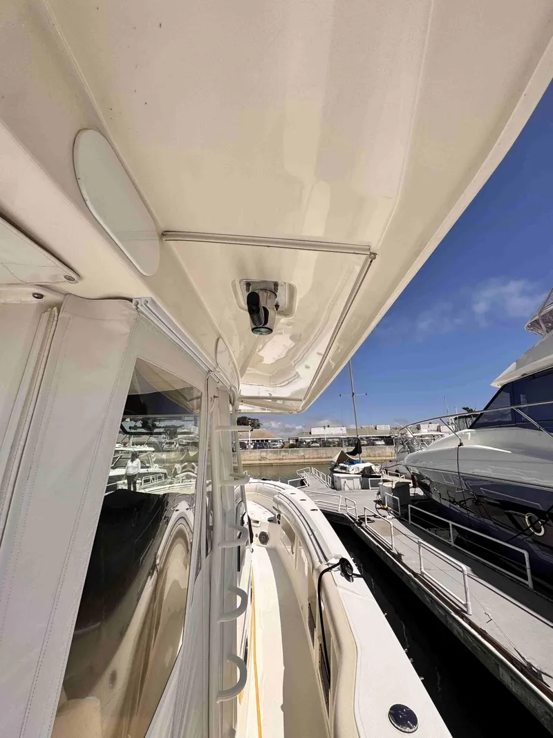 Slide: The Image of 2018 Boston Whaler 350 Outrage docked, showcasing sleek design and spacious deck. - 42