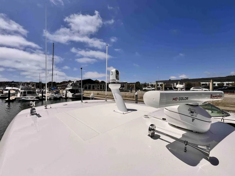 Slide: The Image of 2018 Boston Whaler 350 Outrage at marina, featuring radar and clear blue sky. - 43