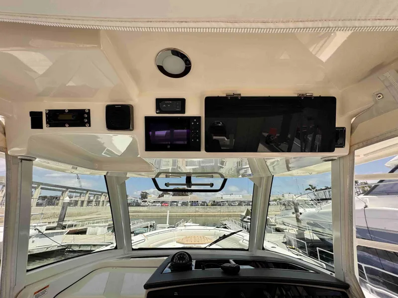 Slide: The Image of Interior view of a 2018 Boston Whaler 350 Outrage boat cockpit with navigation equipment. - 45