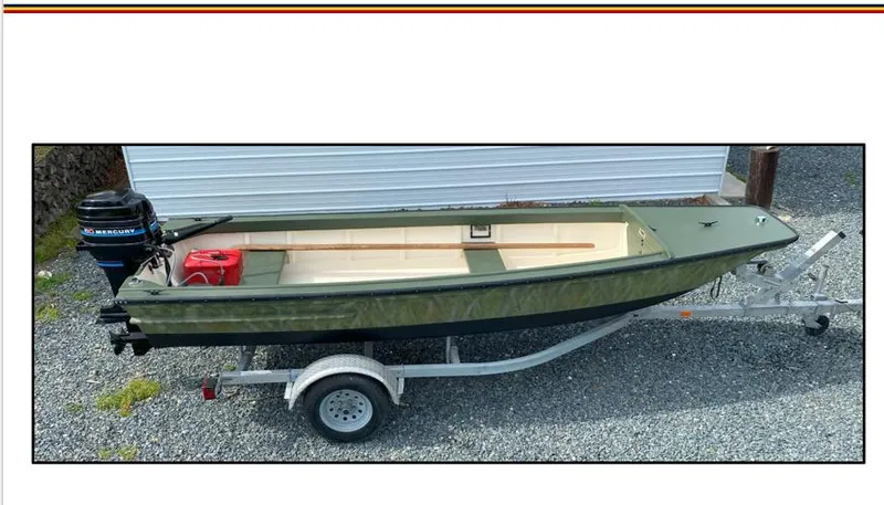 The Image of 1963 Custom Chincoteague Scow boat on trailer with Mercury outboard motor. - 1