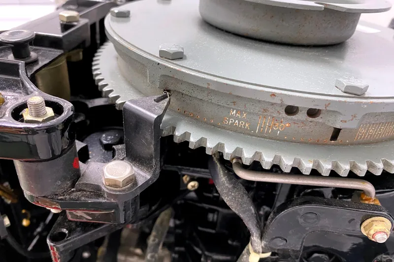 Slide: The Image of Close-up of a 1963 Chincoteague Scow engine component with gear and spark settings. - 6