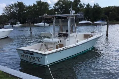 The Image of 1982 Mako 23 Inboard Diesel boat named "Defiance" docked in a serene marina. - 0