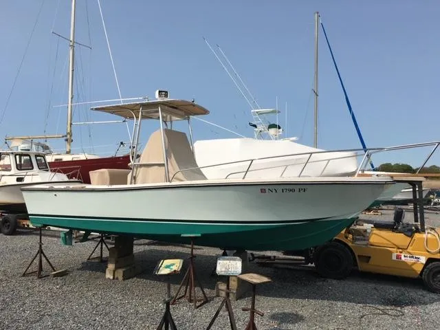 Slide: The Image of 1982 Mako 23 Inboard Diesel boat on stands in a marina. - 10