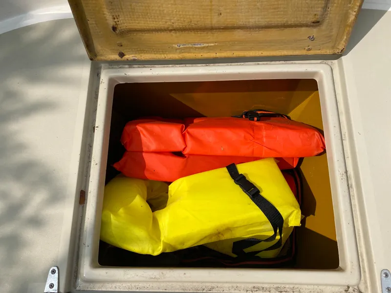 Slide: The Image of Storage compartment on 1982 Mako 23 Inboard Diesel boat with life jackets. - 24