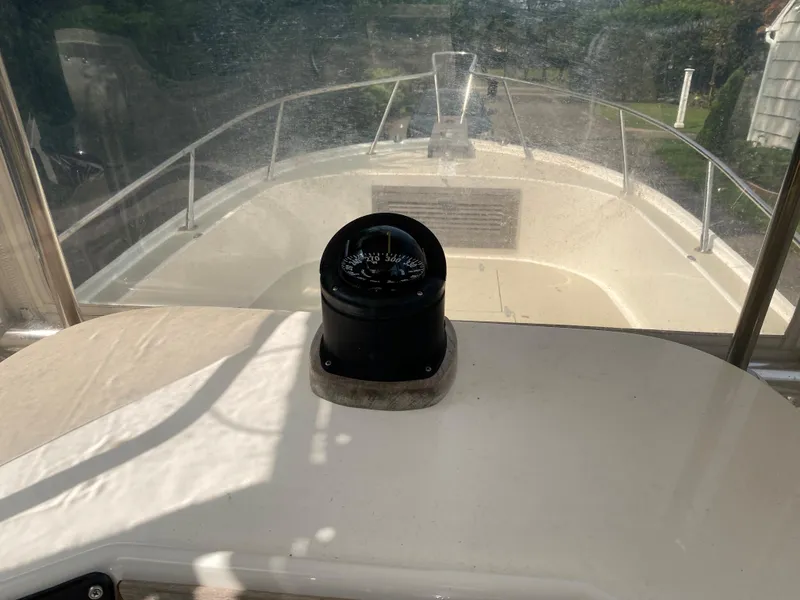 Slide: The Image of 1982 Mako 23 Inboard Diesel boat interior with compass, clear view of bow and railing. - 32