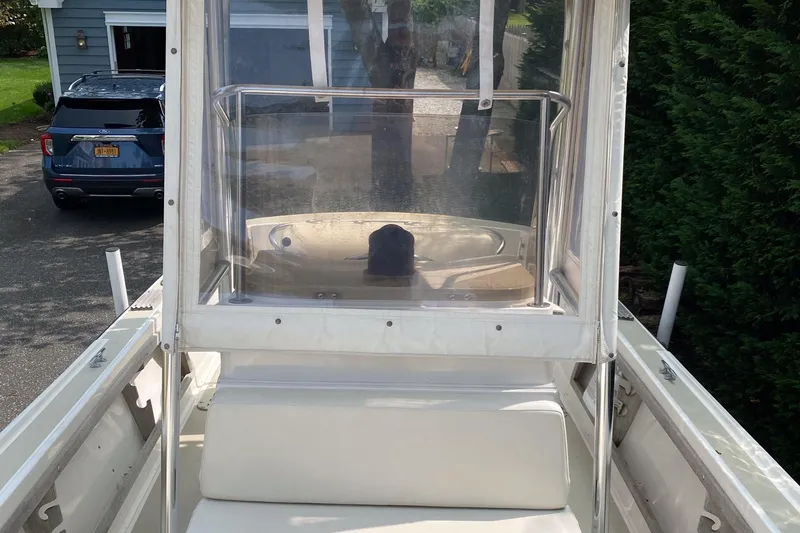 Slide: The Image of 1982 Mako 23 Inboard Diesel boat with clear windshield and white seating. - 37