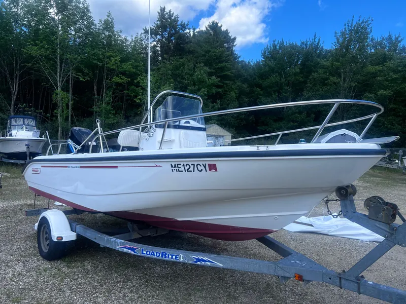 Slide: The Image of 2003 Boston Whaler 180 Dauntless boat on trailer, parked outdoors. - 1