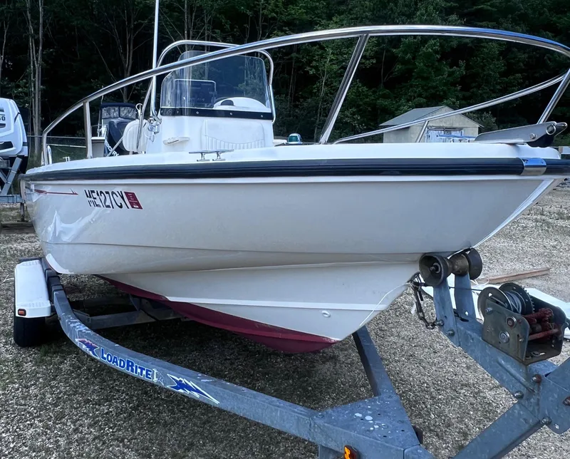 Slide: The Image of 2003 Boston Whaler 180 Dauntless boat on Load Rite trailer, parked outdoors. - 3