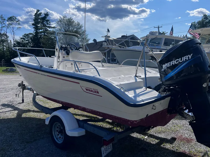 Slide: The Image of 2003 Boston Whaler 180 Dauntless boat with Mercury engine on trailer, outdoors. - 5