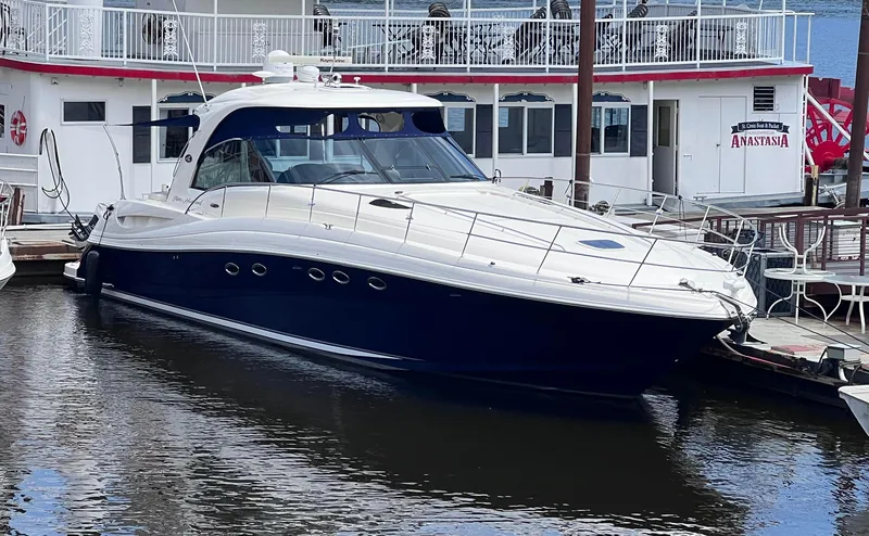 The Image of 2005 Sea Ray 500 Sundancer yacht docked beside a riverboat. - 0