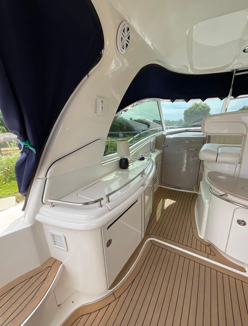 Slide: The Image of Interior of 2005 Sea Ray 500 Sundancer yacht with sleek design and wooden flooring. - 10