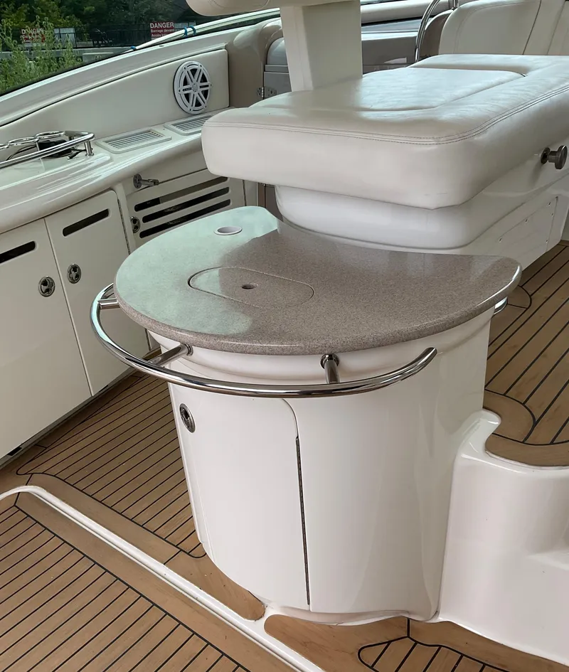 Slide: The Image of Luxury seating area on 2005 Sea Ray 500 Sundancer yacht with sleek design and wood flooring. - 14
