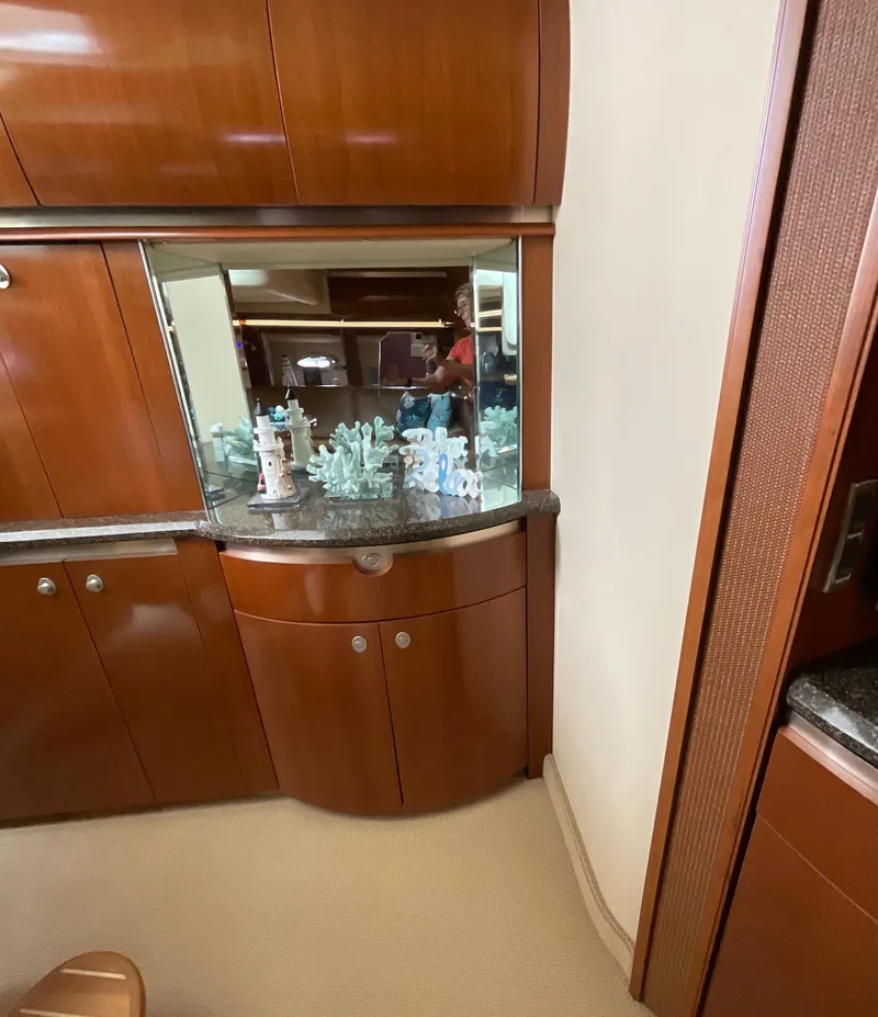 Slide: The Image of Interior of 2005 Sea Ray 500 Sundancer with wooden cabinetry and decorative display. - 17