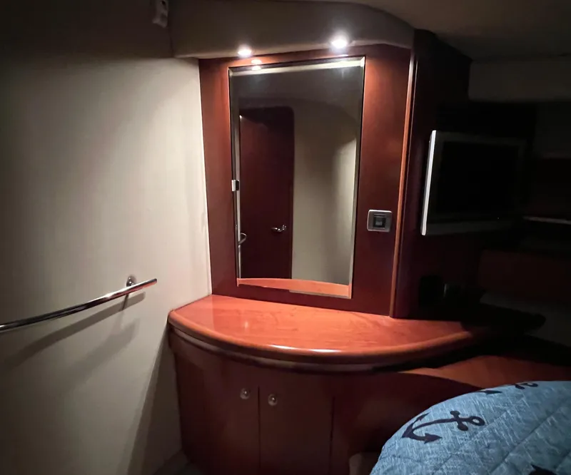 Slide: The Image of 2005 Sea Ray 500 Sundancer cabin interior with mirror and wooden cabinetry. - 28