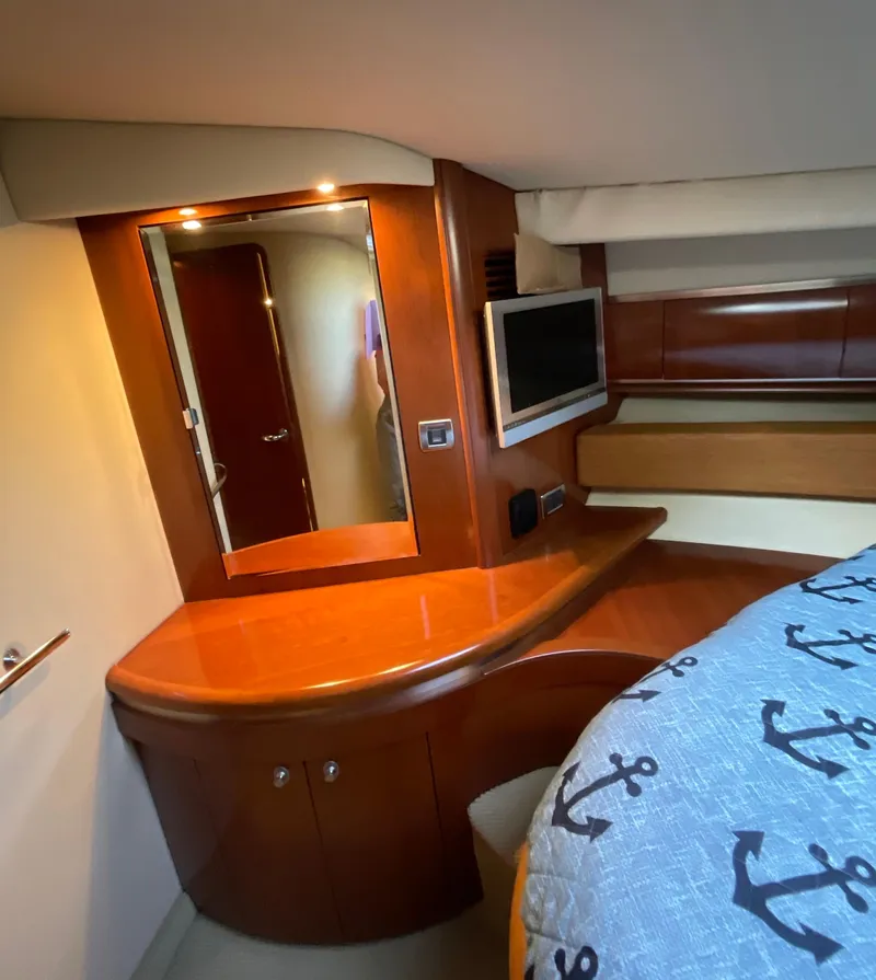 Slide: The Image of Luxurious cabin interior of 2005 Sea Ray 500 Sundancer yacht with wood finish and TV. - 29