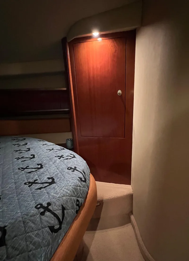 Slide: The Image of Cozy cabin interior of 2005 Sea Ray 500 Sundancer with anchor-patterned bedding. - 30
