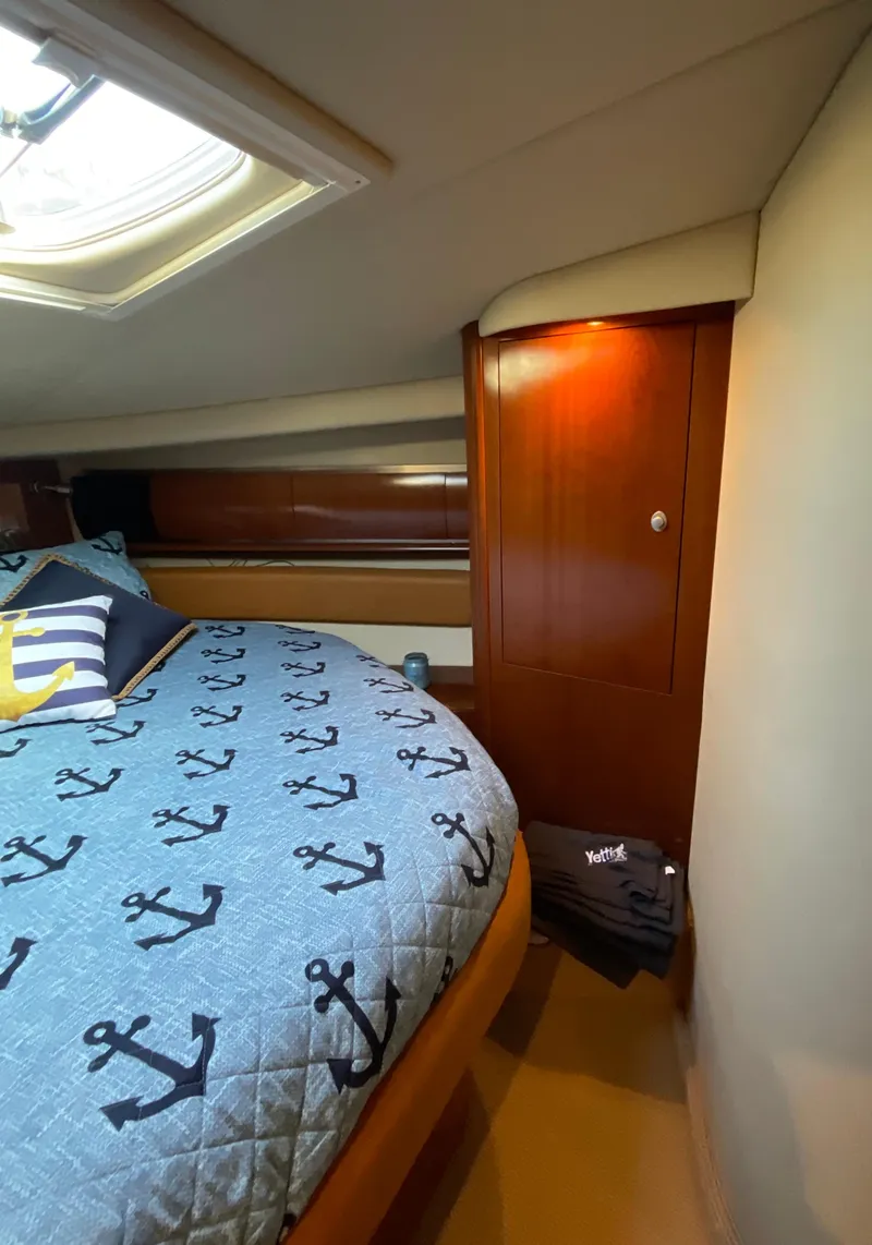 Slide: The Image of Luxurious cabin interior of 2005 Sea Ray 500 Sundancer yacht with anchor-themed bedding. - 31