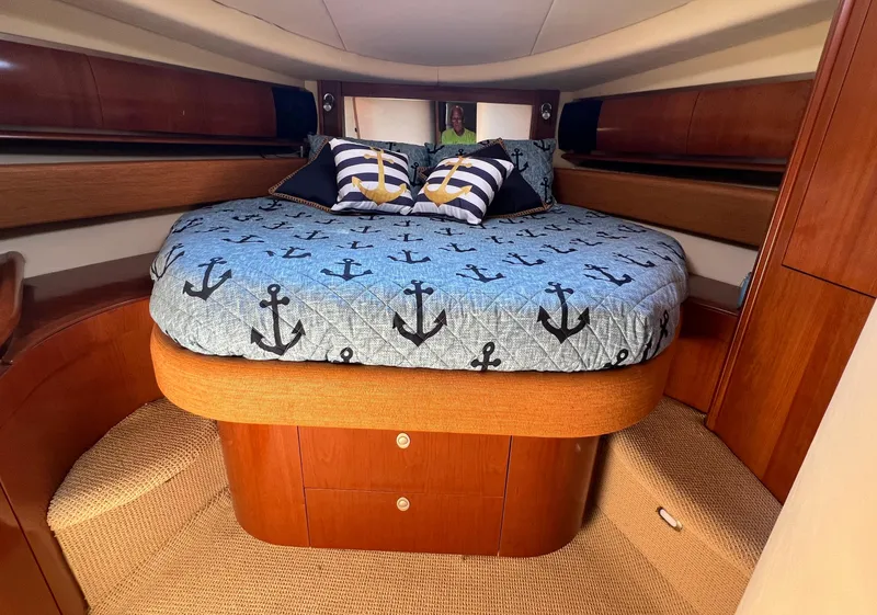 Slide: The Image of Luxurious cabin interior of 2005 Sea Ray 500 Sundancer with anchor-themed bedding. - 32