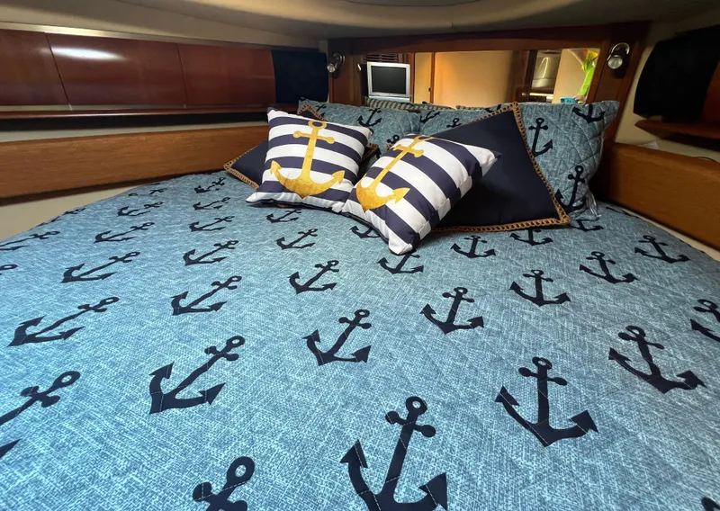 Slide: The Image of Nautical-themed bedroom in 2005 Sea Ray 500 Sundancer yacht with anchor-patterned bedding. - 33