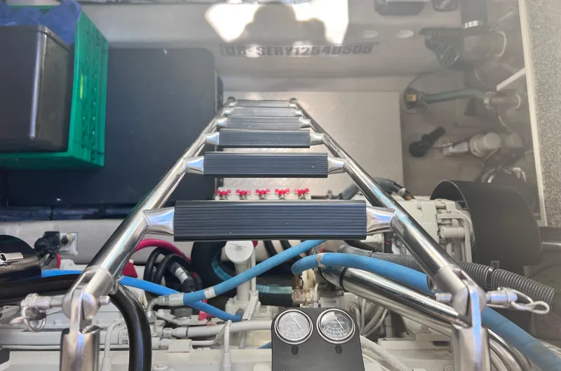 Slide: The Image of Engine room of 2005 Sea Ray 500 Sundancer with ladder and mechanical components. - 34