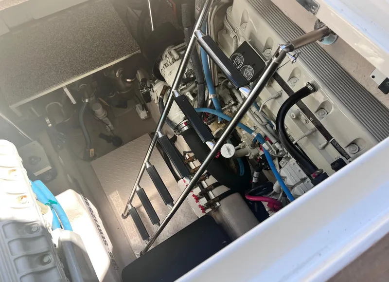 Slide: The Image of Engine compartment of a 2005 Sea Ray 500 Sundancer boat, showcasing mechanical components. - 35