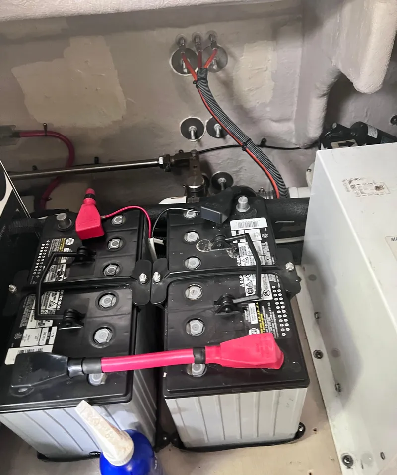 Slide: The Image of Batteries in a 2005 Sea Ray 500 Sundancer engine compartment, showing wiring and connections. - 37