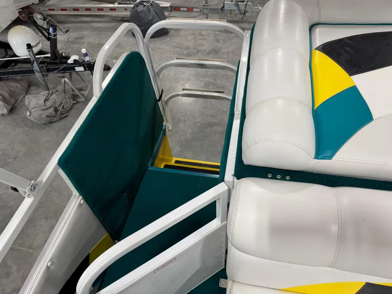 Slide: The Image of 2004 PlayCraft 2800 Powertoon boat interior with colorful seating and green accents. - 10