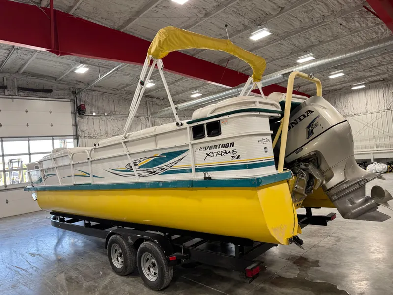 Slide: The Image of 2004 PlayCraft 2800 Powertoon boat with yellow hull on trailer in indoor storage. - 4