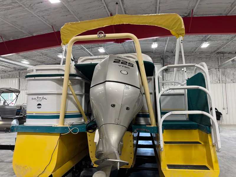 Slide: The Image of 2004 PlayCraft 2800 Powertoon with Honda 225 VTEC engine in a storage facility. - 6