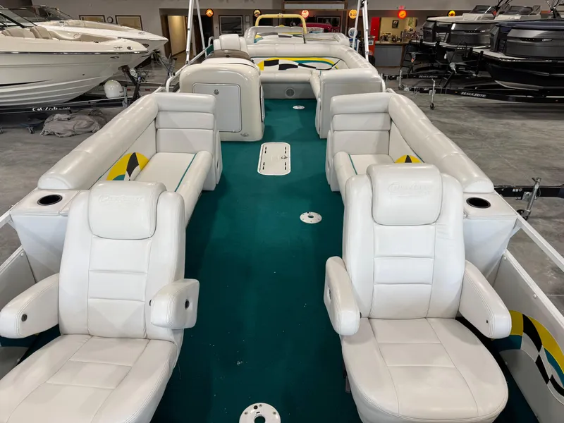 Slide: The Image of 2004 PlayCraft 2800 Powertoon boat interior with white seating and teal carpet. - 7