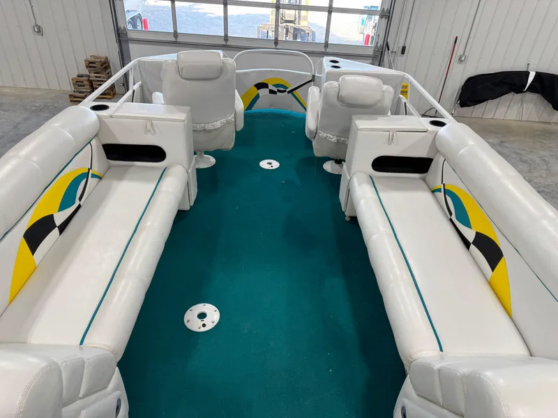Slide: The Image of 2004 PlayCraft 2800 Powertoon interior with white seating and teal carpet in a garage. - 8