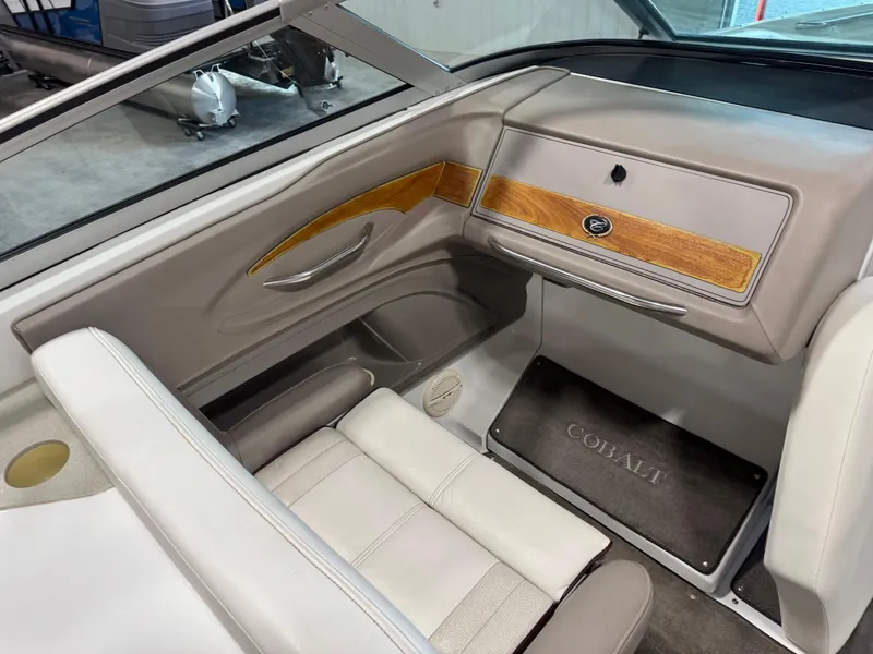Slide: The Image of Interior of a 2000 Cobalt 292 boat with wood accents and beige seating. - 10