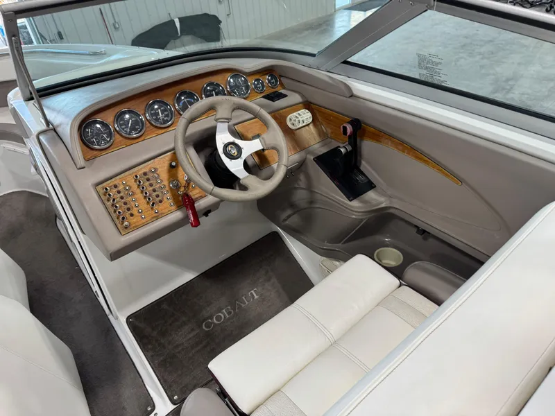 Slide: The Image of Interior of a 2000 Cobalt 292 boat, featuring a detailed dashboard and steering wheel. - 11