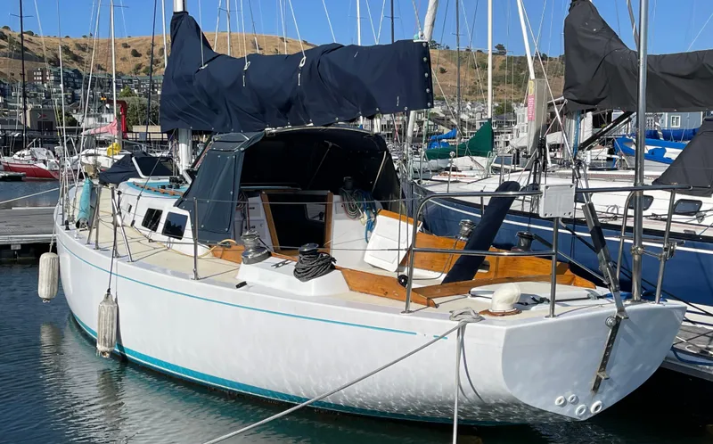 The Image of 1964 CAL 40 sailboat docked in marina, featuring classic design and white hull. - 0