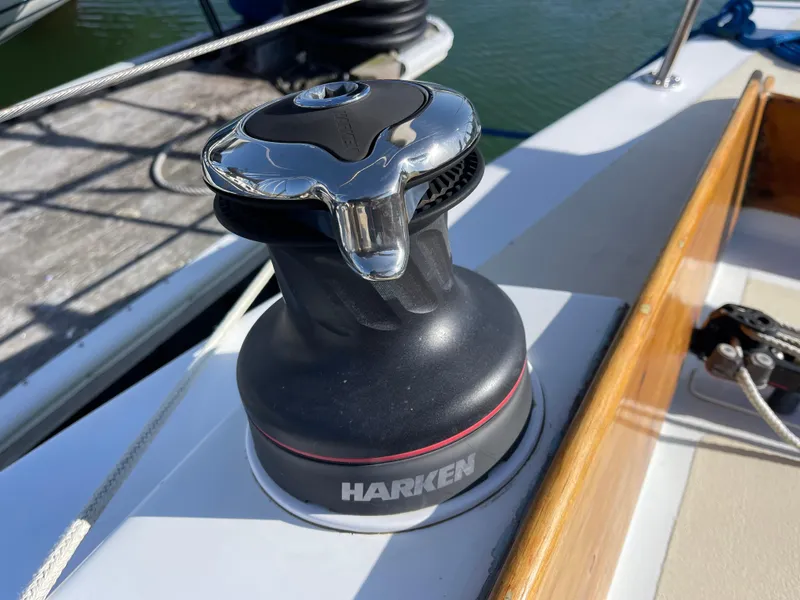 Slide: The Image of Harken winch on a 1964 CAL 40 sailboat deck, with ropes and wooden trim. - 16