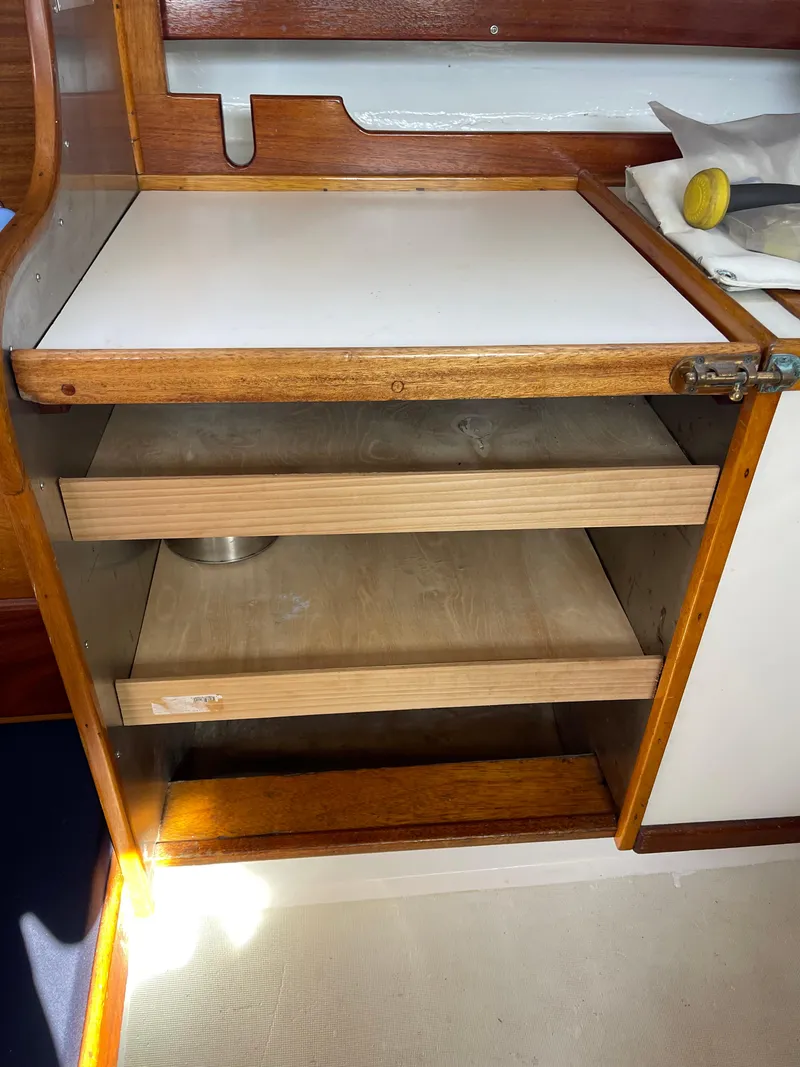 Slide: The Image of Wooden cabinet with open shelves inside a 1964 CAL 40 sailboat interior. - 5