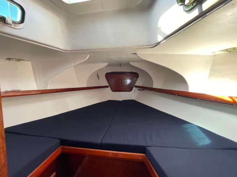 Slide: The Image of Interior cabin of a 1964 CAL 40 sailboat with blue cushions and wooden trim. - 6