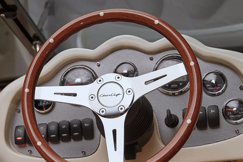 Slide: The Image of Manufacturer Provided Image: 2016 Chris-Craft Carina 21 dashboard with wooden steering wheel and gauges. - 3