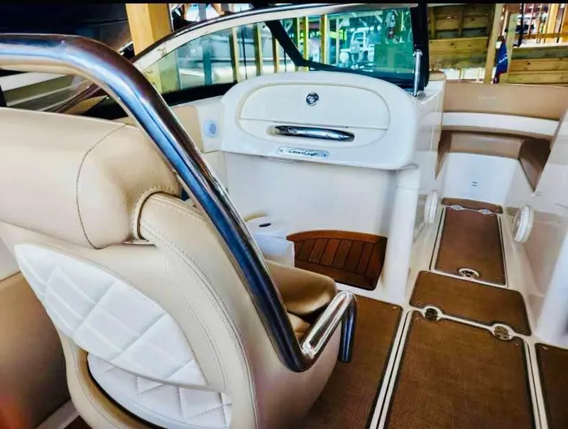 Slide: The Image of 2016 Chris-Craft Carina 21 interior with beige leather seats and elegant design. - 6
