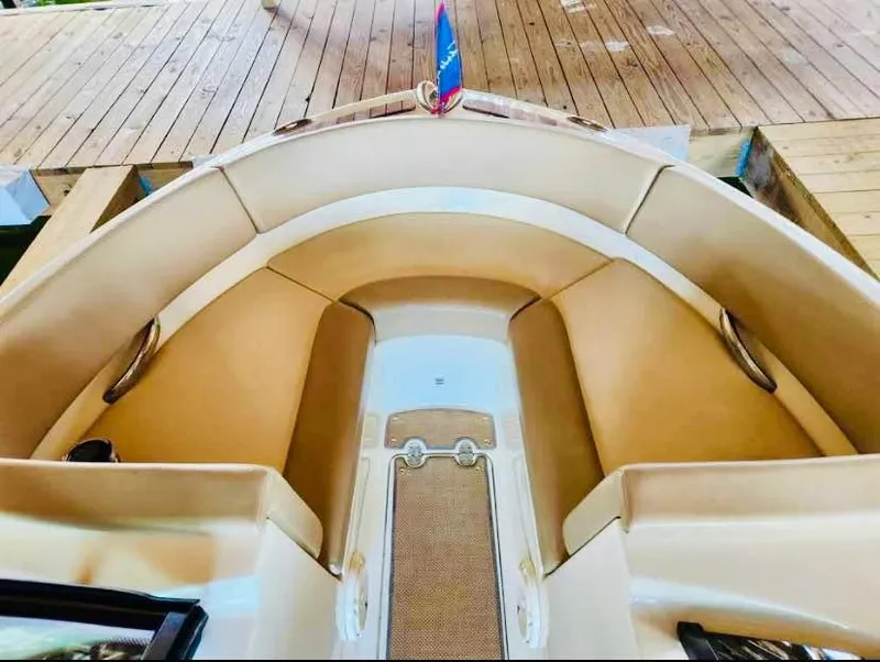 Slide: The Image of 2016 Chris-Craft Carina 21 boat interior with tan seating and wooden deck. - 8