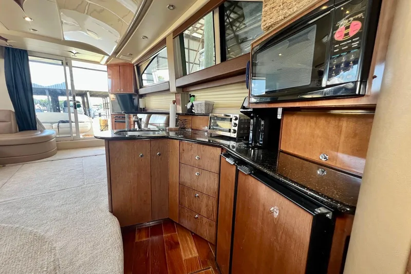 Slide: The Image of Luxurious interior of a 2008 Meridian 391 Sedan yacht with modern kitchen amenities. - 12