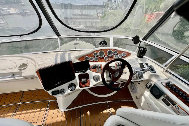 Slide: The Image of 2008 Meridian 391 Sedan helm with wood accents, steering wheel, and navigation instruments. - 13