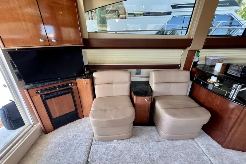 Slide: The Image of Interior of 2008 Meridian 391 Sedan with beige seating, TV, and wooden cabinetry. - 17