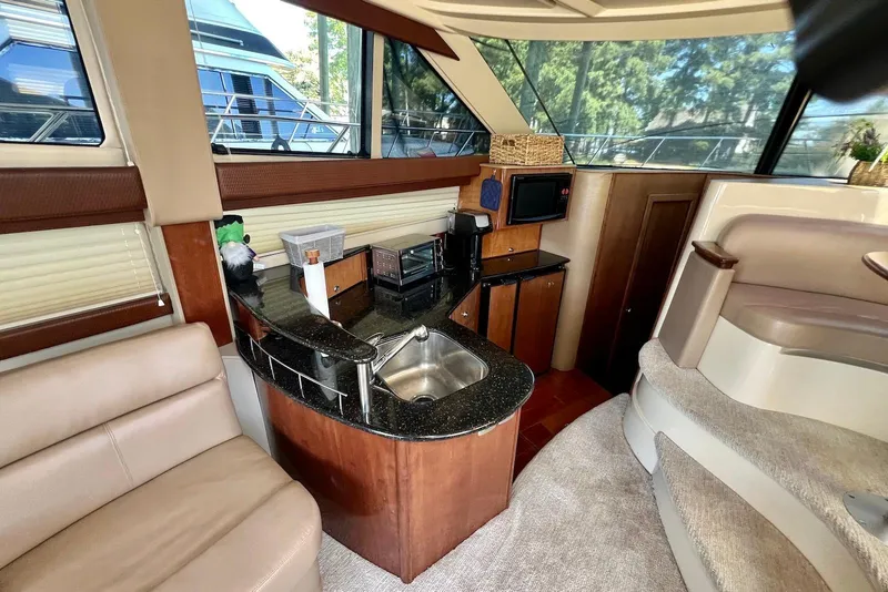 Slide: The Image of 2008 Meridian 391 Sedan interior with kitchenette, featuring sink, microwave, and seating area. - 20