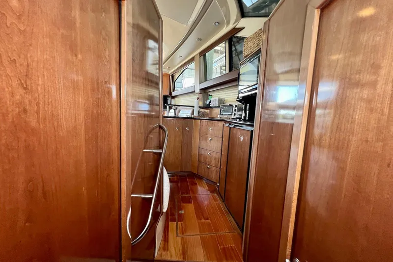 Slide: The Image of Interior of 2008 Meridian 391 Sedan yacht with wooden cabinetry and modern appliances. - 23