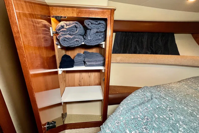 Slide: The Image of Wooden cabinet with folded towels inside a 2008 Meridian 391 Sedan yacht bedroom. - 25