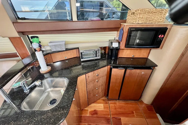 Slide: The Image of Compact kitchen in 2008 Meridian 391 Sedan yacht with sink, microwave, and appliances. - 30