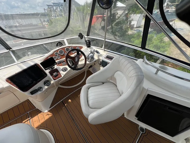Slide: The Image of 2008 Meridian 391 Sedan helm with luxurious seating and modern controls, overlooking marina. - 4