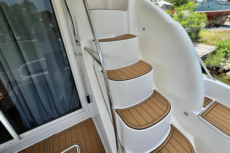 Slide: The Image of Staircase on 2008 Meridian 391 Sedan yacht with teak steps and stainless steel railing. - 6