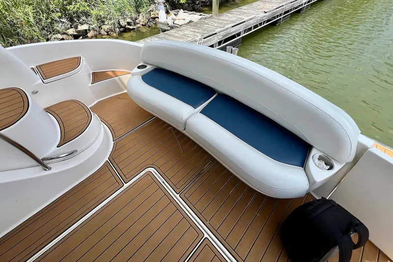 Slide: The Image of 2008 Meridian 391 Sedan boat interior with cushioned seating and wooden deck. - 7